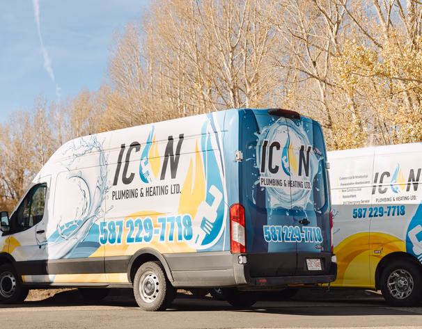 Icon Plumbing & Heating Ltd. service vans featuring blue and yellow water and flame branding with phone number 587-229-7718.